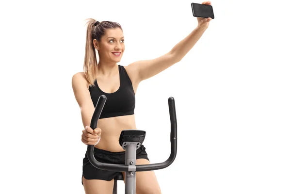 Young Woman Exercising Cross Trainer Machine Taking Selfie Isolated White — Stock Photo, Image