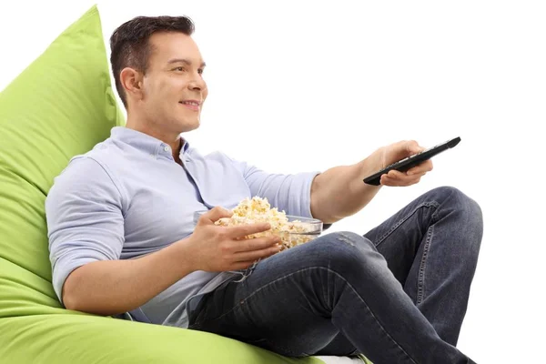 Man Bowl Popcorn Remote Control Sitting Beanbag Watching Television Isolated — Stock Photo, Image