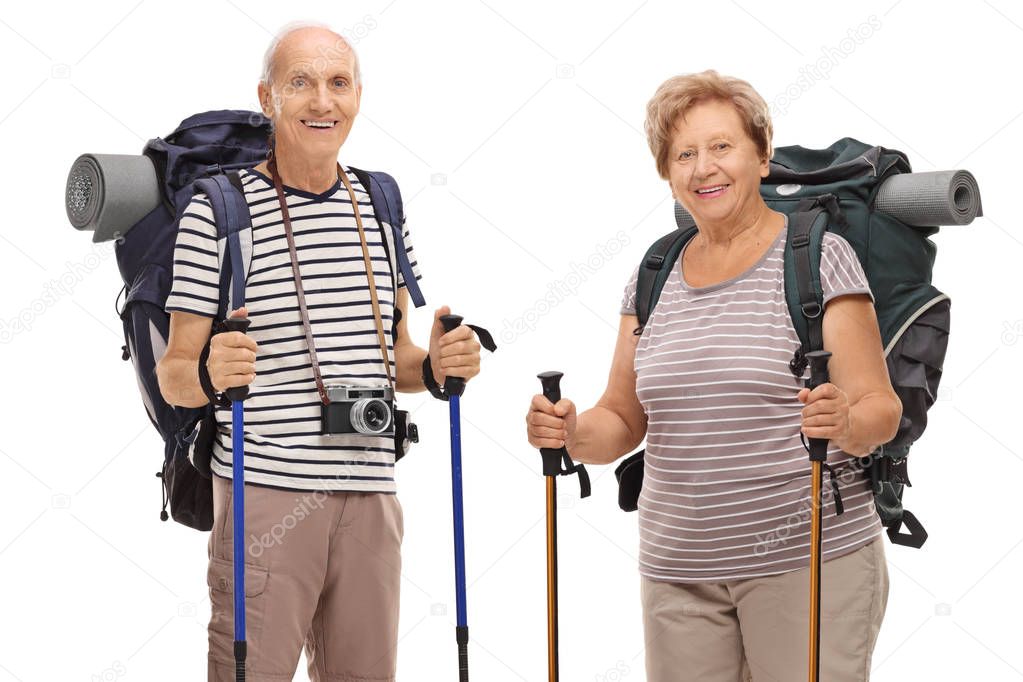 Elderly hikers looking at the camera and smiling isolated on white background