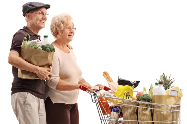 Älteres Paar Mit Einer Einkaufstasche Und Einem Einkaufswagen Voller Lebensmittel — Stockfoto