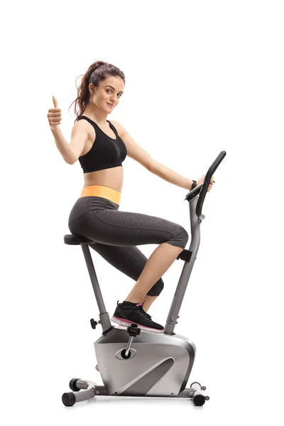 Fitness Woman Riding Exercise Bike Making Thumb Sign Isolated White — Stock Photo, Image