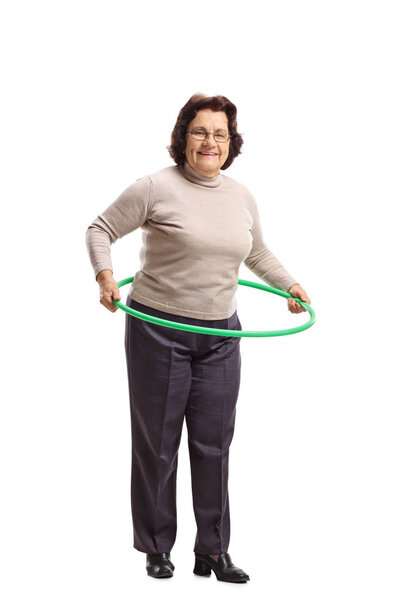 Full length portrait of an elderly woman with a hula-hoop isolated on white background