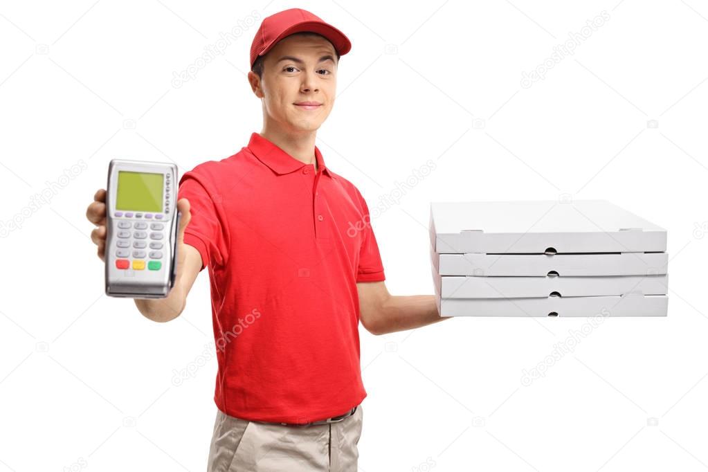 Teenage delivery boy holding a payment terminal and pizza boxes isolated on white background