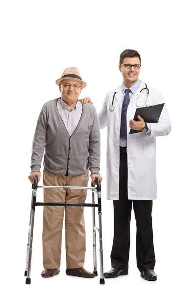 歩行器と白い背景に分離された医師の高齢患者の完全な長さの肖像画 — ストック写真