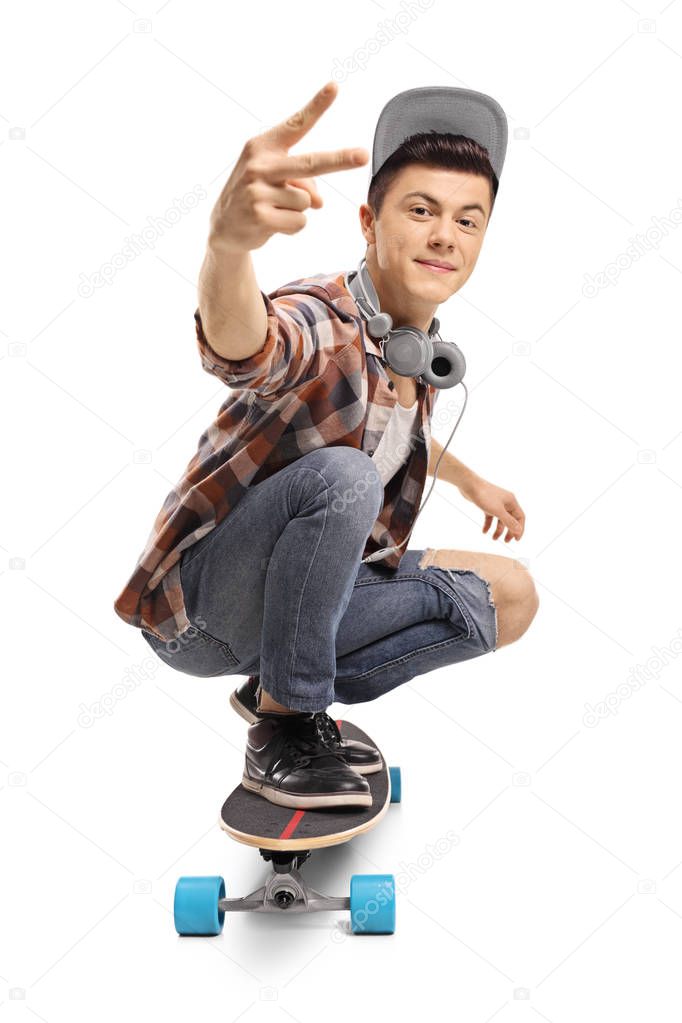 Teenager with a longboard making a peace gesture isolated on white background
