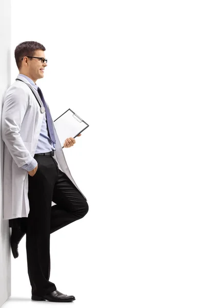 Full Length Profile Shot Doctor Clipboard Leaning Wall Isolated White — Stock Photo, Image