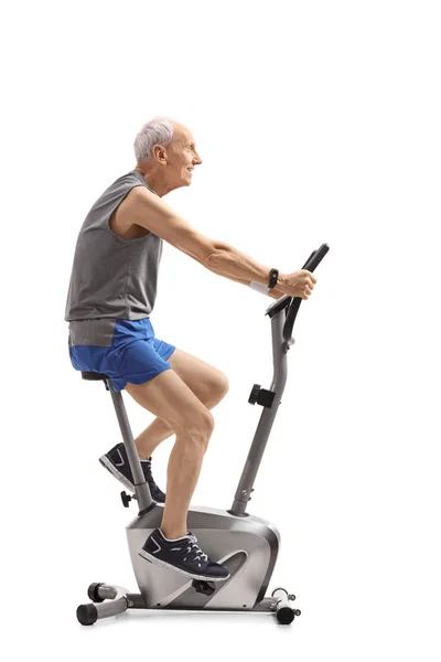 Senior Rijden Een Hometrainer Geïsoleerd Witte Achtergrond — Stockfoto