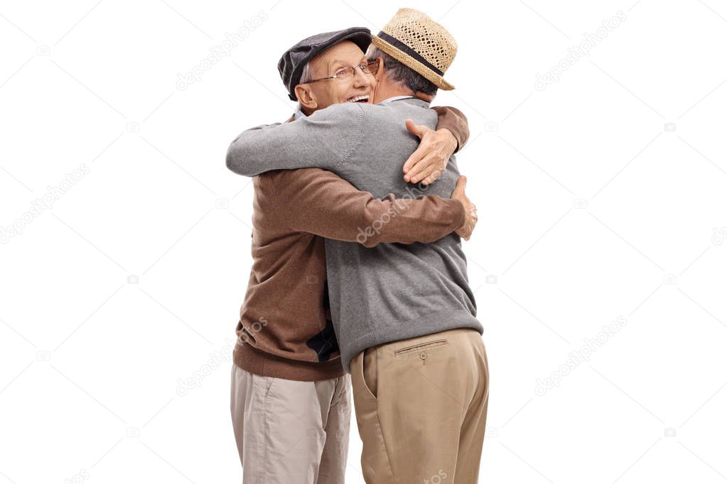 Two elderly men hugging each other isolated on white background