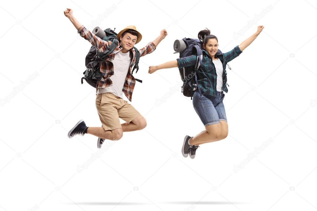 Teenage tourists jumping and gesturing happiness isolated on white background