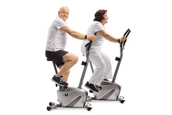 Mature Man Mature Woman Exercising Stationary Bikes Isolated White Background — Stock Photo, Image