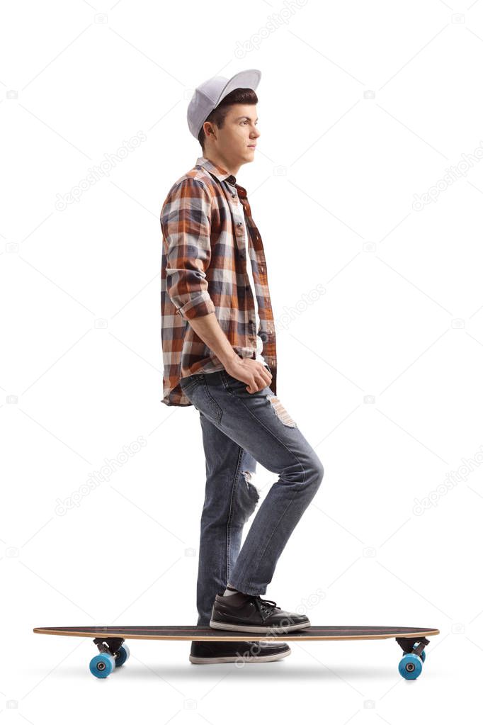 Full length profile shot of a teenage skater with a longboard waiting in line isolated on white background