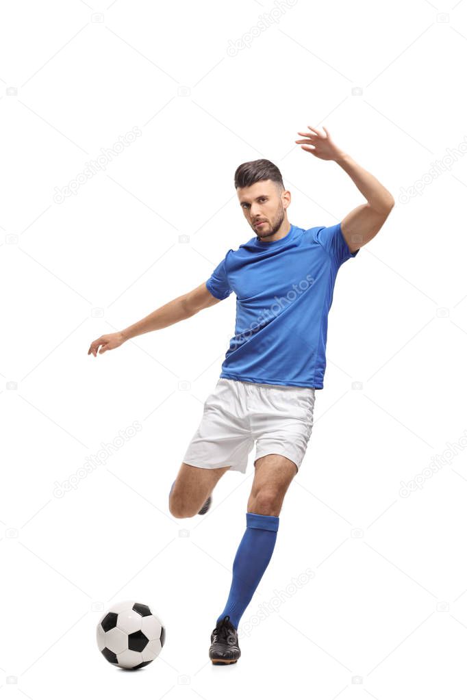 Soccer player kicking a football isolated on white background