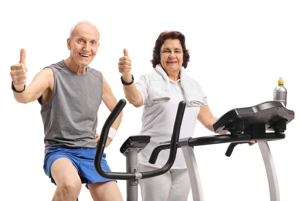 Elderly Man Stationary Bike Elderly Woman Treadmill Holding Thumbs Isolated — Stock Photo, Image