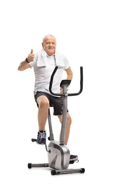 Пожилой Человек Стационарном Велосипеде Делает Большой Палец Вверх Жест Изолирован — стоковое фото