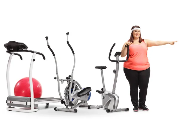Full Length Portrait Overweight Woman Standing Exercise Machines Pointing Isolated — Stock Photo, Image