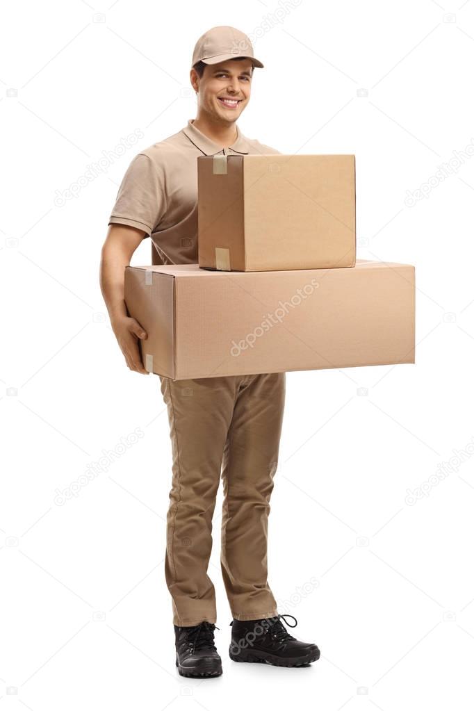 Full length portrait of a delivery man with packages isolated on white background