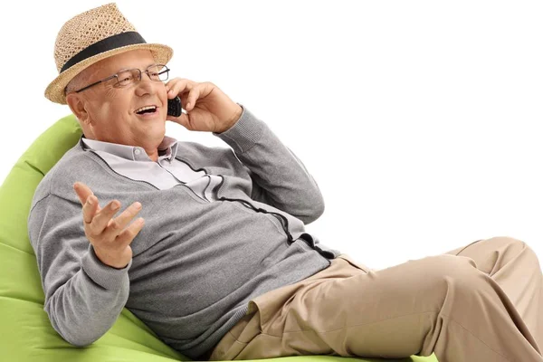 Mature Man Sitting Green Beanbag Talking Phone Isolated White Background — Stock Photo, Image