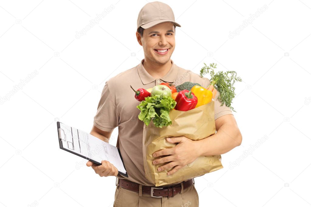 Delivery guy holding a clipboard and a grocery bag isolated on white background