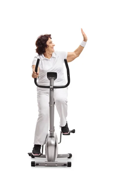 Elderly Woman Exercising Stationary Bike Making High Five Gesture Isolated — Stock Photo, Image