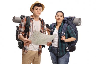 Lost teenage tourists with a map isolated on white background clipart