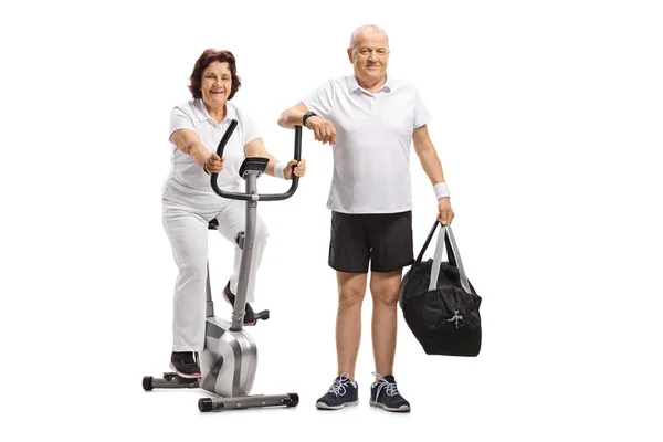 Mature Woman Stationary Bike Mature Man Sports Bag Isolated White — Stock Photo, Image