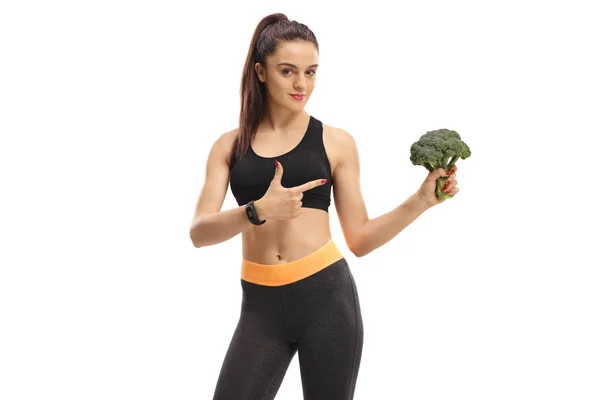 健身妇女举行花椰菜和指向孤立的白色背景 — 图库照片