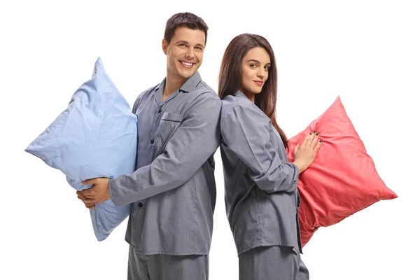 Young Couple Pajamas Backs Each Other Holding Pillows Isolated White — Stock Photo, Image