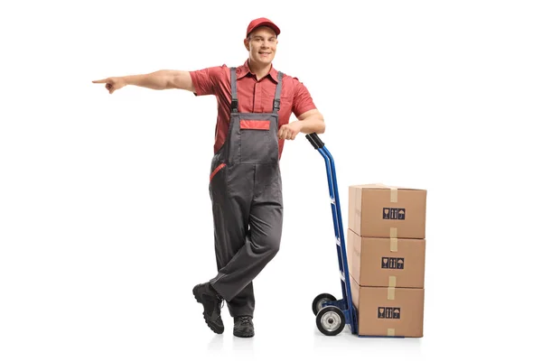 Full Length Portrait Mover Leaning Hand Truck Stack Boxes Pointing — Stock Photo, Image