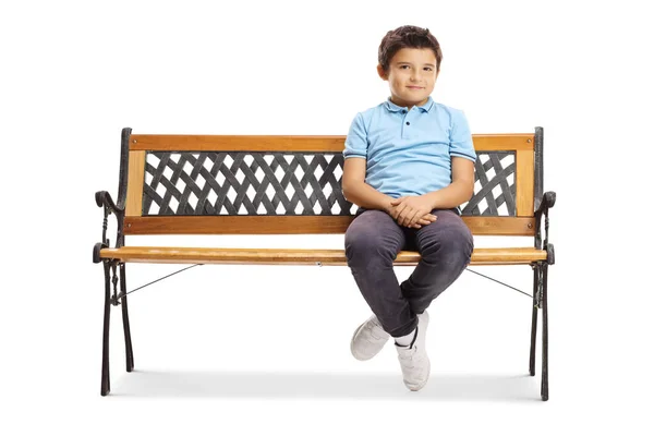 Усміхнений молодий хлопчик сидить на лавці і дивиться на камеру — стокове фото