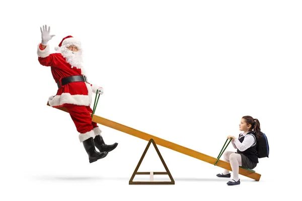 Święty Mikołaj machający z huśtawki i bawiący się z uczennicą — Zdjęcie stockowe