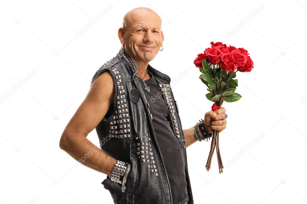 Bald punk holding a bunch of red roses and smiling