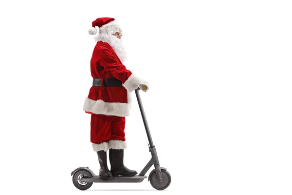 Santa Claus riding an electric scooter — Stock Photo, Image