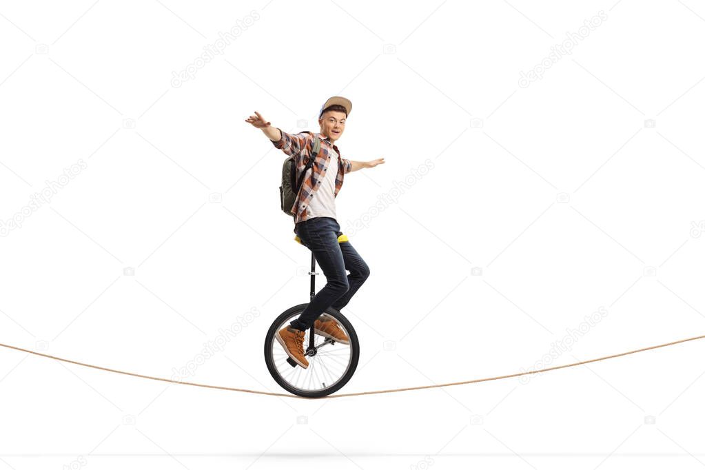 Male teenager riding a unicycle 