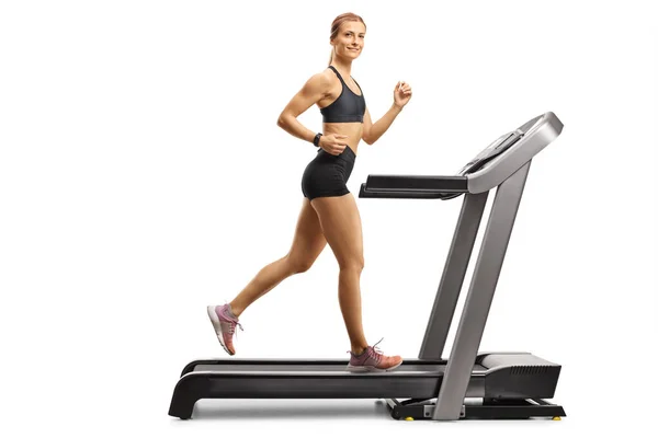 Mujer atractiva corriendo en una cinta de correr —  Fotos de Stock