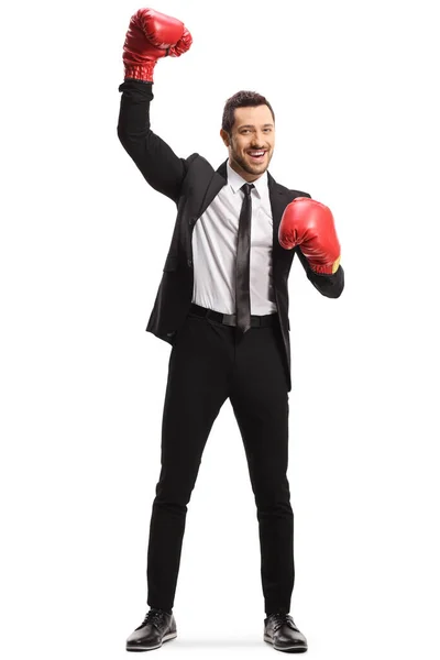 Homem de terno com luvas de boxe levantando uma mão como vencedor — Fotografia de Stock