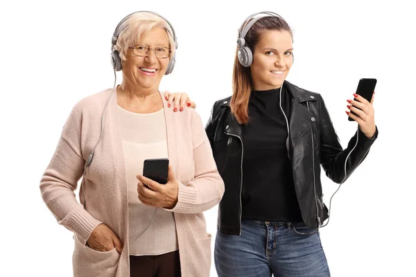 Cool grandmother and granddaughter listening to music on headpho — Stock Photo, Image