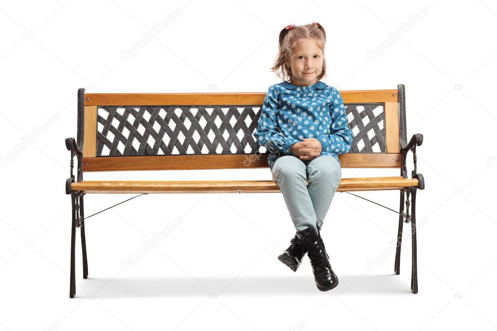 Little girl sitting on a bench and looking at the camera