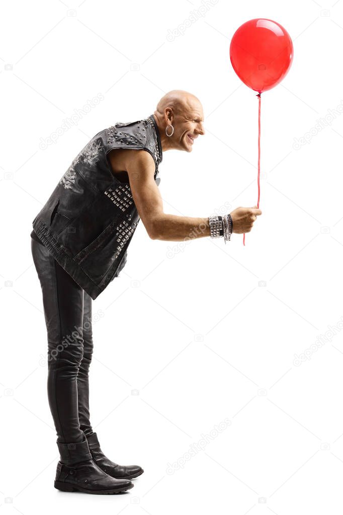 Bald man in leather clothes giving a red baloon
