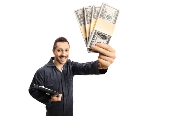 Repairman with a clipboard holding stacks of money — Stock Photo, Image