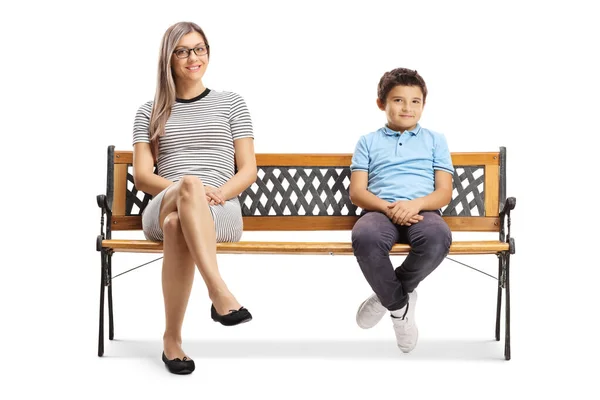 Boy witting on a bench next to his mother — Stok Foto