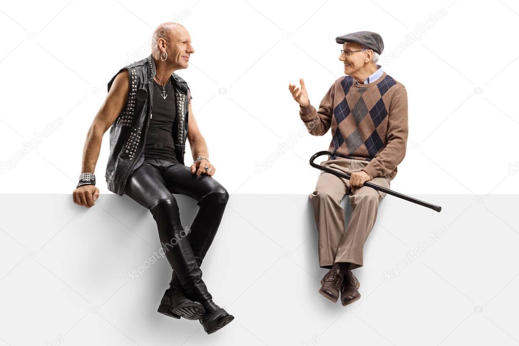 Punk and a senior man sitting on a panel and having a conversati