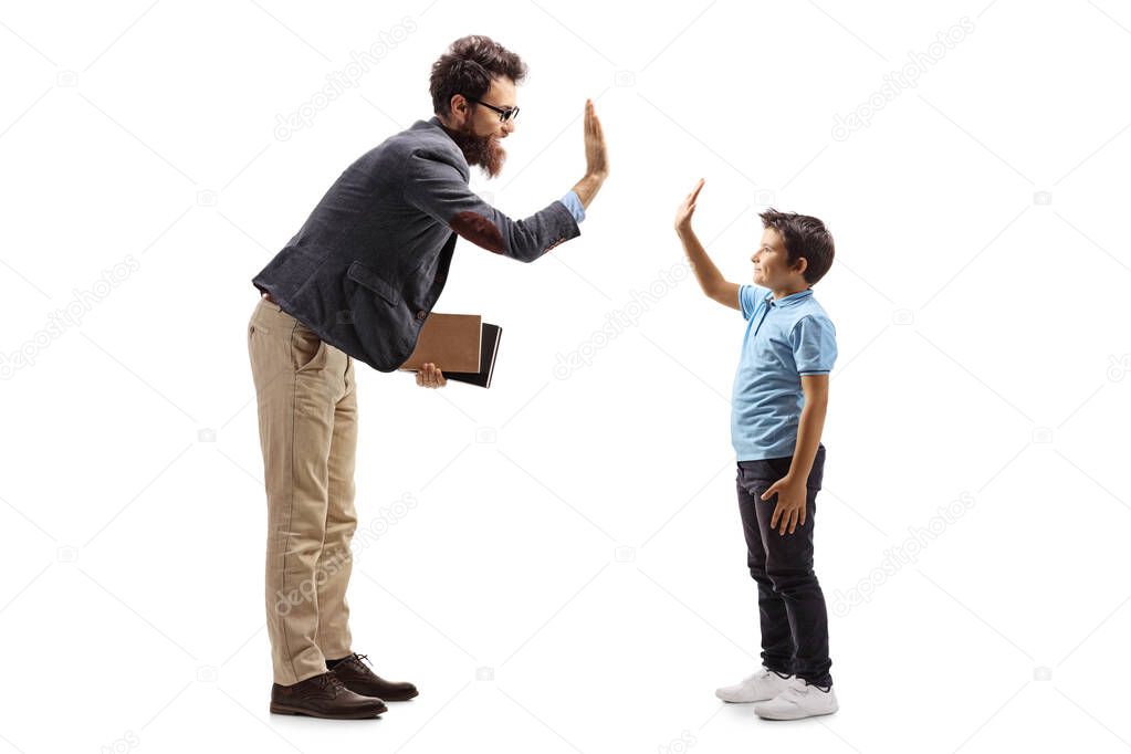 Man holding books and gesturing high-five with a boy
