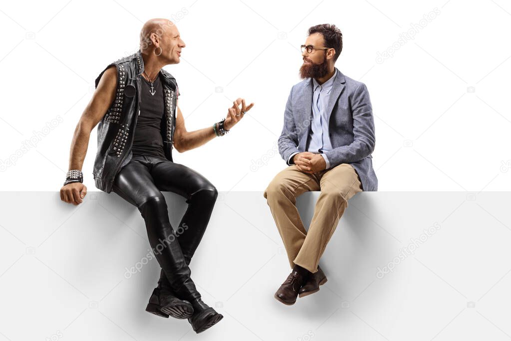 Bearded man listening to a punk talking on a panel 