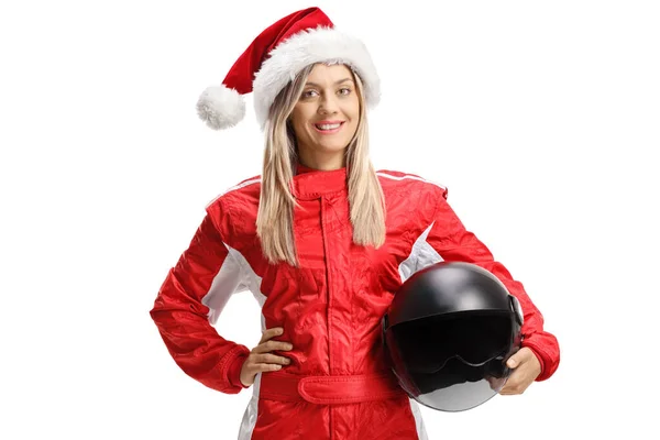 Female racer wearing a Santa Claus hat and holding a helmet — Stockfoto