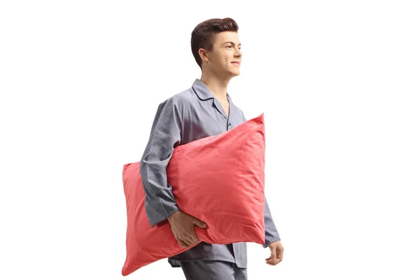 Teenager in pajamas holding a pillow — Stockfoto