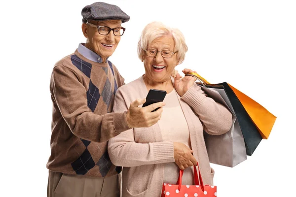 Seniorpar med mobiltelefon og handleposer – stockfoto