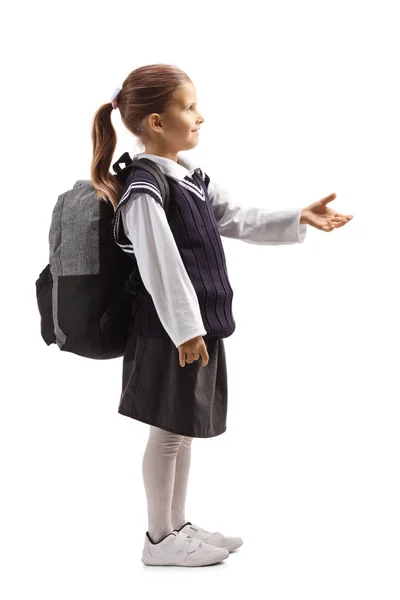 Schoolmeisje wachten om iets te nemen met haar hand — Stockfoto