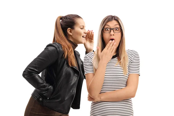 Young woman telling a secret to another young woman — Stock Photo, Image