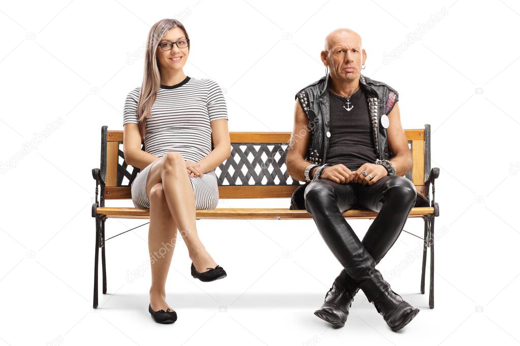 Young blond woman and a grumpy punker sitting on a bench