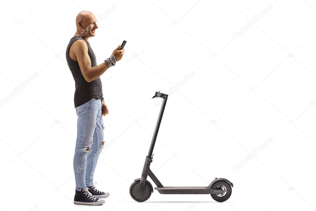 Bald male hipster renting a scooter with a mobile phone applicat